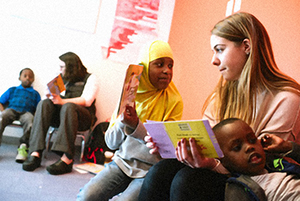 college students reading to children